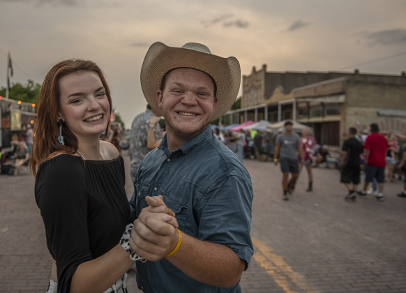 Alex Harwell, left, dances with Jordan Rhoades on West Davilla Street (closed to traffic) during the second night of Granger's Lakefest on Friday, May 12, 2023.