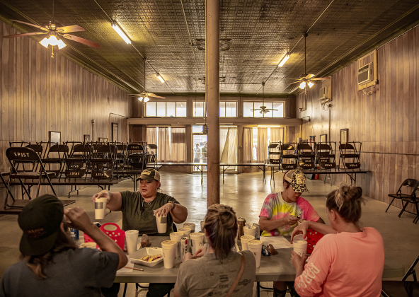 Kelbi Dlouhy, facing camera at left, Magan Kaderka, facing camera at right, Eric Kaderka, back to camera at left, Amber Vrana, back to camera center, and Kate Barrett, back to camera at right, judge  Barbecue Cook-off bean category entries inside the historic S.P.J.S.T. building, built in 1909, on Saturday, May 13, 2023.