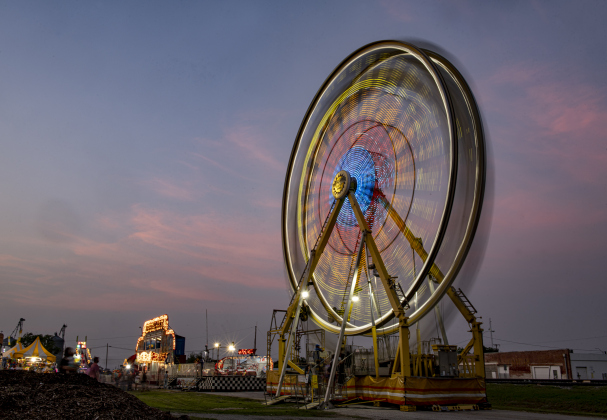 The Thomas Carnival midway Ferris wheel spins on Thursday, May 11, 2023.