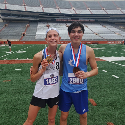 Mckenzie Bailey, who placed first in the girls 3,200 meter and third in the girls 1,600, stands with Joseph Wienen, who finished third in the boys 3,200 meter event. 