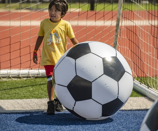 6-year-old Tyler Lee Joiner, a student at Williams Elementary School, takes part in an event that utilizes a very large inflatable soccer ball.