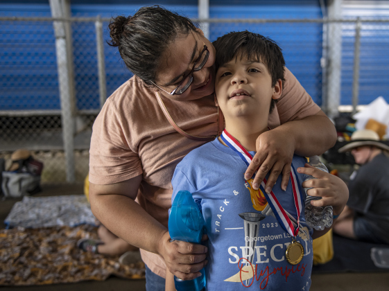 8-year-old Sirius Rendon is embraced by his mother Celeste Rendon after morning competition concluded.