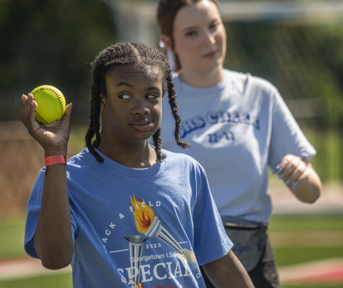 14-year-old Miles Wilson, a student at East View High, concentrates on a softball throw.