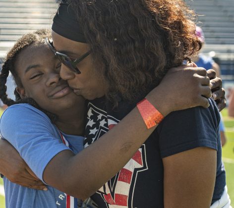 14-year-old Miles Wilson, a student at East View High, gets embraced by his mom Yvette Wilson after he competed in the softball throw.