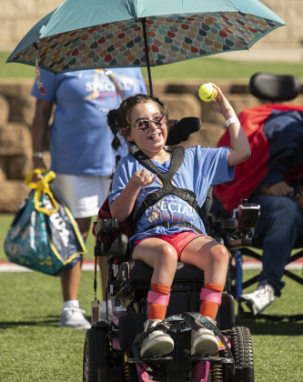 11-year-old Skylar Del Bosque, a student at McCoy Elementary School, takes part in the tennis ball throw.