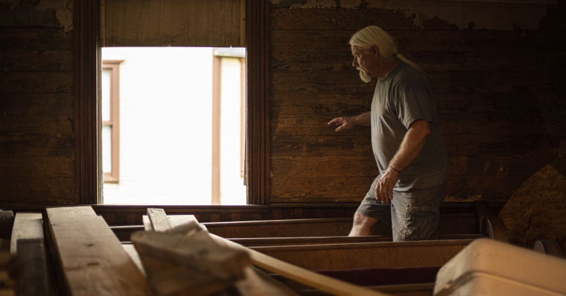 Robert Halstrom closes windows before calling it a night at what was once Granger United Methodist Church.