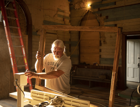 Robert Halstrom makes improvements to framing for a stained glass window  at what was once Granger United Methodist Church on Monday, May 22.