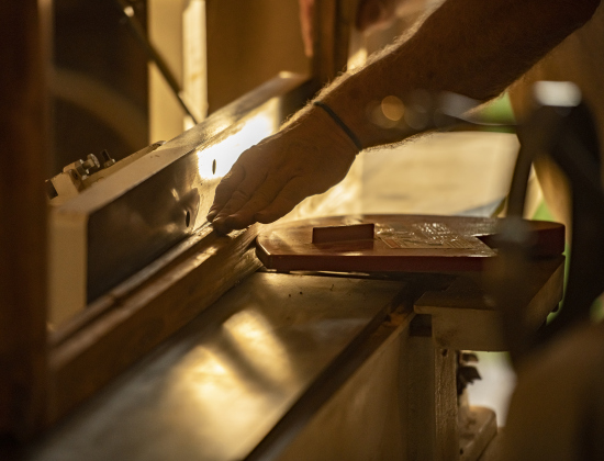 Robert Halstrom makes adjustments to framing that will again hold a stained glass window.