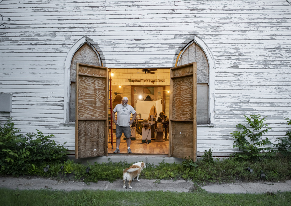 Robert Halstrom and his dog Ladybug relax near day's end at what was once Granger United Methodist Church on Monday, May 22.  Halstrom and his wife Joanne bought the circa 1904 church in 2019.  The project has continued since then, but  then Joanne was dealt a  a life-altering accident in March  2022.  The project has been put on hold for months, but slowly, Halstrom is back at work. Photos by Andy Sharp