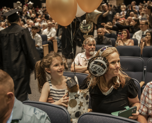 7-year-old Landry Locklin and her mom Jennifer Locklin wait to congratulate Landry's sister (and Jennifer's daughter) Brooke Locklin, 17.