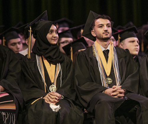 Class Salutatorian Marwa Azizi, left, and her brother, class Valedictorian Walid Azizi, are shown at the Commencement ceremony for Richarte High School, held at the Klett Performing Art Center on Thursday, May 25. The school's top graduates came here from Afghanistan with their family in 2022.