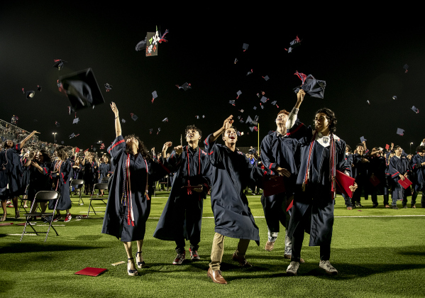 ast View High School graduating seniors toss their mortarboards into the air after receiving their diplomas.