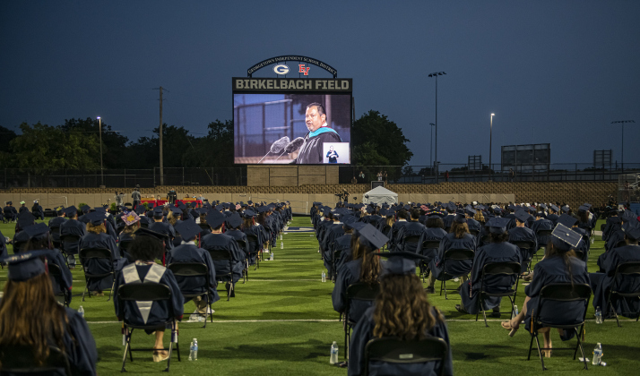 East View High School Principal Alfonso Longoria fills a large screen as he speaks to graduating seniors at  Birkelbach Field for their 2023 Commencement on Friday, May 26. A total of 457 students received their diplomas.