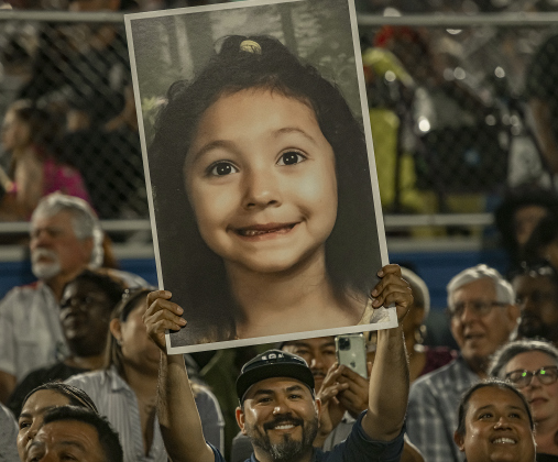 Erick Reyes holds up a large family  photo of his niece Maria Guadalupe Salas Reyes, one of 457 graduates from East View High School during  2023 Commencement on Friday, May 26.