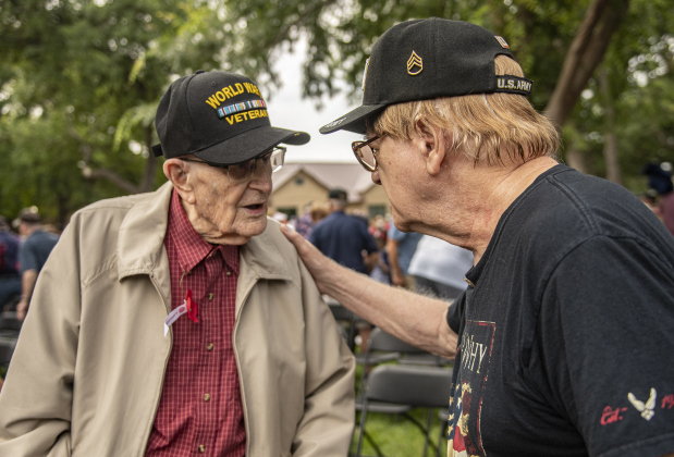 World War II Air Force veteran Ralph May, 96, left, visits with Army veteran Gary Knoepke, 82, right, at  the Sun City Texas Community Association Memorial Day observance held Monday, May 29.