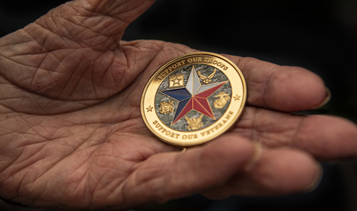 Ernie Columbus, a 103-year-old World War II Army veteran, holds a medallion given to him by a member of Governor Greg Abbott's staff during  the Sun City Texas Community Association Memorial Day observance held Monday, May 29.