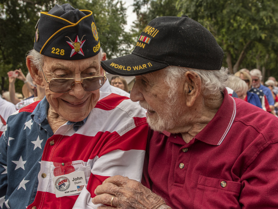 John Dunn, left, a World War II Navy veteran who turns 95 in August, visits with World War II Army veteran Ernie Columbus, 103, during the Sun City Texas Community Association Memorial Day observance held Monday, May 29.