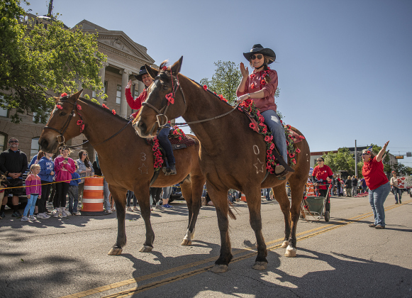 Members of ROCK (Ride On Center for Kids) participate in the parade during the Red Poppy Festival.