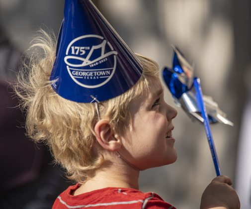 Alden Conrad, 4, had just the right toy for a windy morning to accompany his 175th county anniversary cap as he waited for the start of the parade along Austin Avenue.