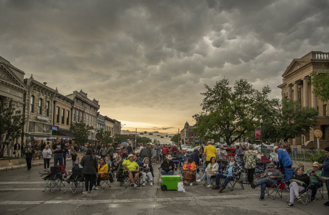 Red Poppy Festival attendees along Austin Avenue wait for the start of a concert  on Friday evening, April 28, 2023.  Rain, accompanied by hail and high winds in some areas, moved through Williamson County throughout the evening.
