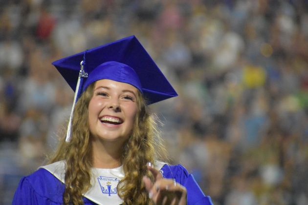 Cassie Partee smiles on stage.
