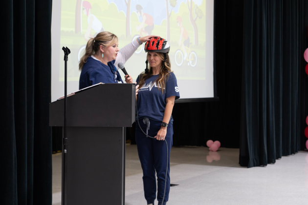 Kristen Hullum, trauma injury prevention coordinator at St. David’s Round Rock Medical Center, demonstrates a proper helmet fitting on Jessica Gregg for students at Annie Purl Elementary School in Georgetown. Photo courtesy the Williamson County Sheriff's Office