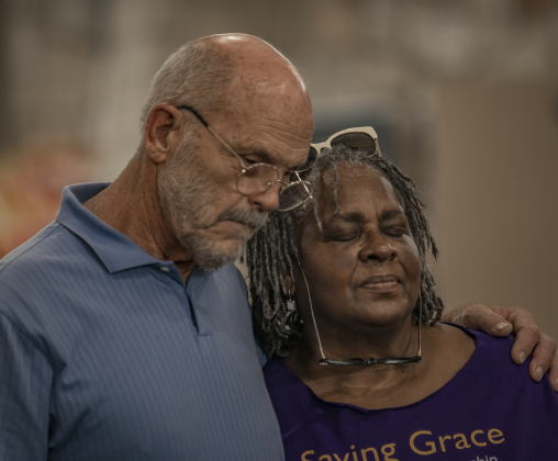 Michael and Evelyn Nichols bow their heads for a prayer.