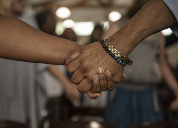 Attendees joined hands for the singing of "Reach Out and Touch" near the program's conclusion.