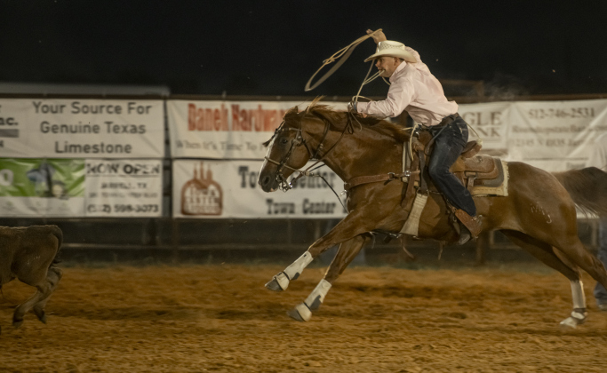 Blake Eggl of Huffsman, Texas competes in Tie Down Roping.