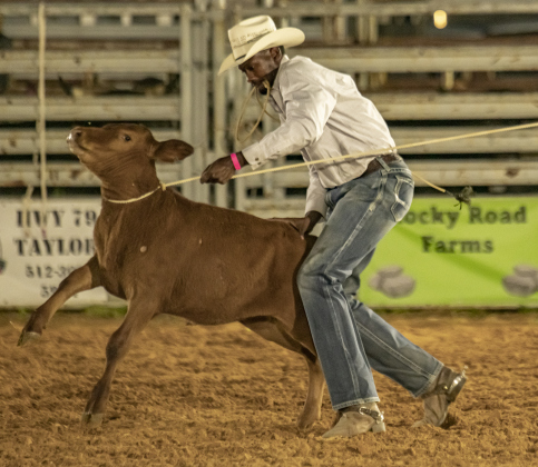 Eddie Dever of Bellville, Texas, competes in Tie Down Roping.