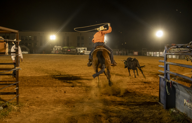 Reece Dunham of Burney, Texas competes in Team Roping.
