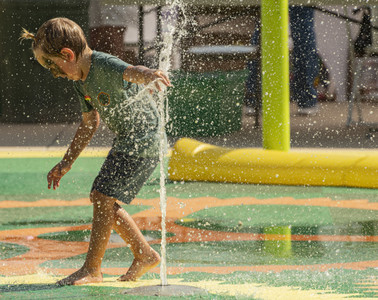 Hank Pawlowski, 4, cools off in the park splash pad.