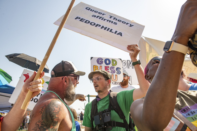Caleb Ripple, center, a pastoral assistant with Taylor's Christ Fellowship Church, was joined by others in opposition to  the 2023 Taylor Pride Festival, held Saturday, June 24, 2023 at Heritage Square Park in Taylor.  The man at left arguing with Ripple only identified as Tony.   A group opposed to Ripple's presence, attempted to block him from view.