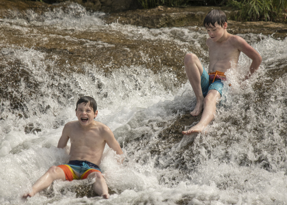 13-year-old Jon Martinez, left, and his twin brother Jake, right, had fun beating the June heat at Blue Hole Park on Saturday, June 3, 2023.