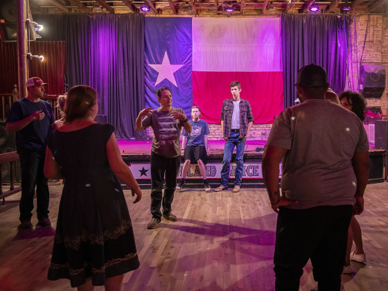 Russell Kinder (facing camera, gesturing)  owner (with his wife Erika)  of Coupland Dancehall, conduct a free  dance class on Sunday afternoon, June 4, 2023.
