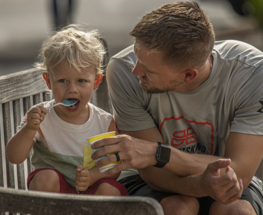 2-year-old Landon Kaliszewski enjoys a frozen iced treat with his dad Adam Kaliszewski.