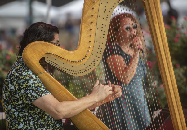 Harpist Ricky Rasura accompanies his wife Amber Rasura, as they perform as Amber Dreams.