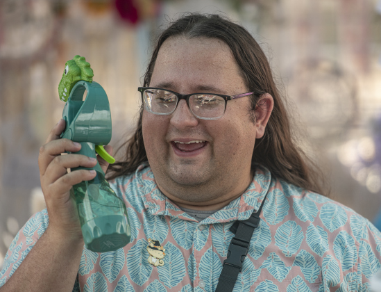 Vendor Blake Jones, whose business is Glorious KnickKnacks, cools off with a portable misting fan.
