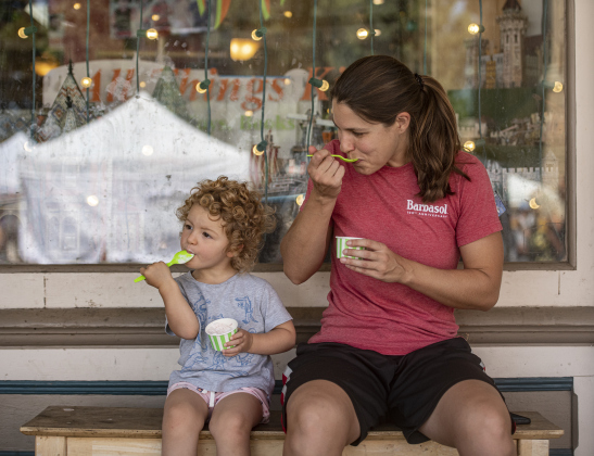 Amy Masheter and her daughter Hannah Daniels, 2, found a shady Main Street spot to enjoy some cool ice cream.