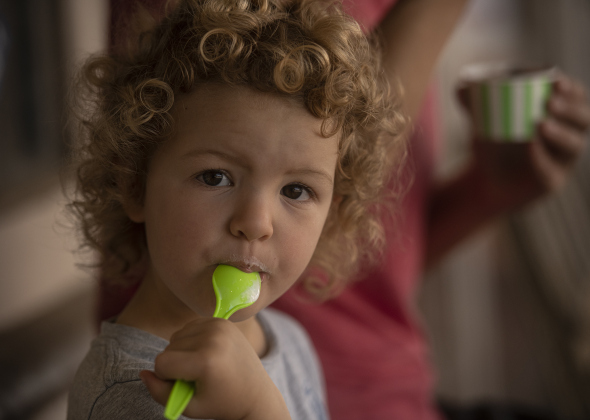 Two-and-a-half year-old Hannah Daniels enjoyed some cool ice cream in a shady Main Street spot while attending Georgetown's Market Days with her mom, Amy Masheter.