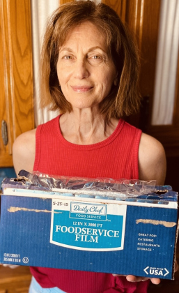 Paula Powers holds a cling wrap boxes. The box is are dated May 2015.