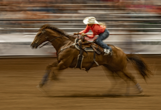 Kathryn Giese of Huntsville, Texas makes a dash across the arena after competing in Barrel Racing.