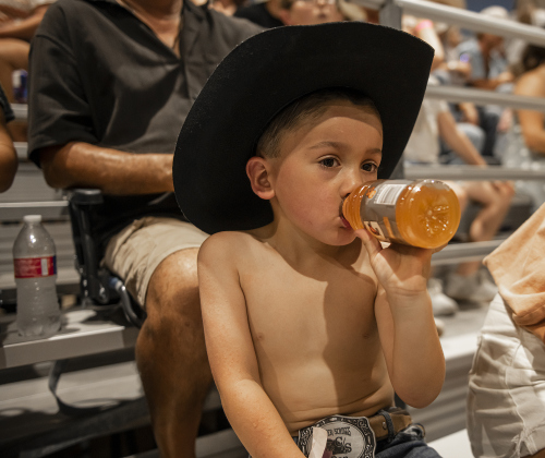 4-year-old rodeo attendee Bennett Kiesling decided going shirtless and having a bit of Gatorade was a key to beating the heat.