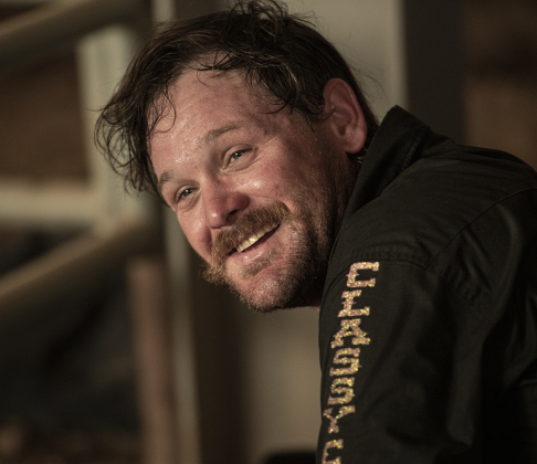 Despite the heat, Bareback Riding competitor Justin Lewis of Kirbyville, Texas managed a smile as he prepared to ride.