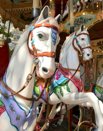 “Childhood Happiness” by Ellen Greeney is included in the current exhibit at Downtowner Gallery through September 8. The image captures an antique carousel in Avignon, France.