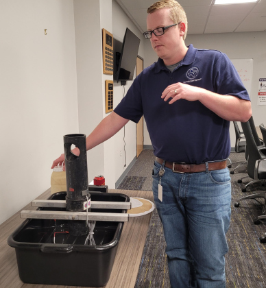  Jason Fritz,  Williamson County City Health District Integrated Vector Management Program lead, assembles a mosquito trap. Photo by Nalani Nuylan.
