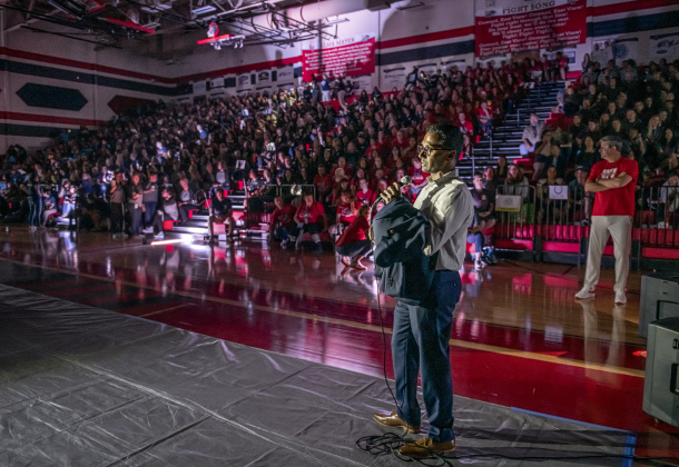 New Superintendent Devin Padavil addresses teachers and students during Tuesday's convocation. A power outage left them in darkness at the East View High School gymnasium, and he had to end the event early. Photo by Andy Sharp. 