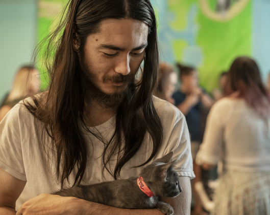 William Balfour cuddles the kitten he adopted during the Georgetown Animal Shelter's kitten adoption event held at the Georgetown Public Library on Thursday, August 10, 2023.  All 19 kittens brought to the library were adopted at a reduced adoption fee.