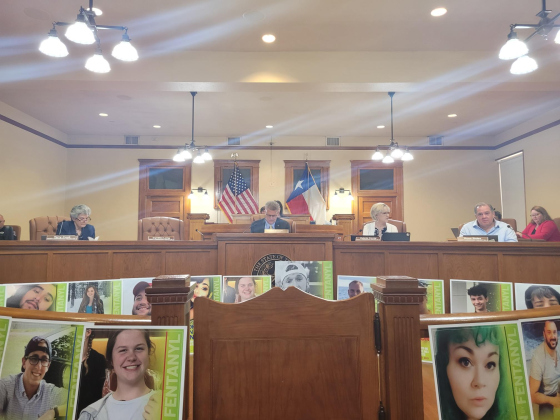 Photos of “angels” who lost their lives to fentanyl poisoning line the county courtroom during an August 15 meeting. Photo by Nalani Nuylan.