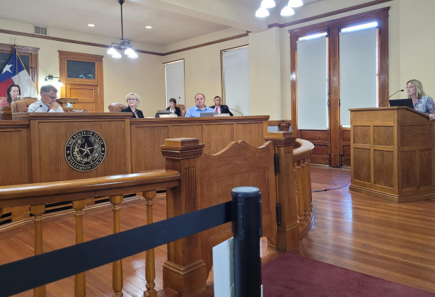 Williamson County Auditor Julie Kiley answers questions about billing the non-county dispatch services at the August 1 Commissioners Court meeting. Photo by Nalani Nuylan.  